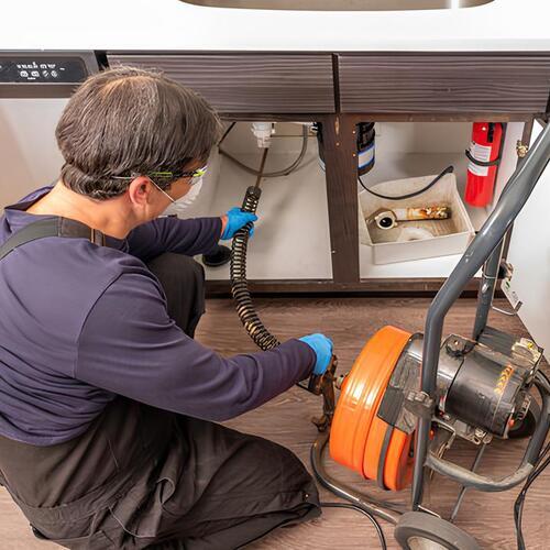 plumber providing drain cleaning services